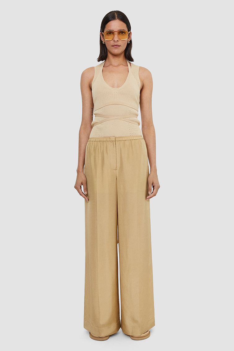 Front view of female model wearing wide cut trousers